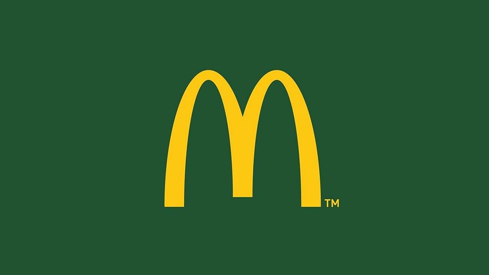 Дизайн логотипа McDonalds в зелено-желтых цветах Логотип McDonalds с фирменной буквой M на зеленом фоне